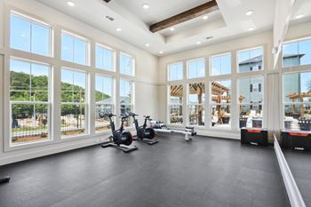 A spacious room with a treadmill and exercise bike.